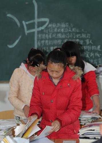 灾区关键词:“复课” 4月24日,四川省雅安市宝兴县中学的高三学生在整理被地震震落的书籍。当日,宝兴县中学近180名高三学生复课,第一堂课的内容是心理辅导。 新华社记者 罗晓光摄